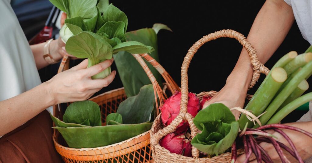 Close-up of hands holding wicker baskets filled with fresh vegetables and fruits outdoors.