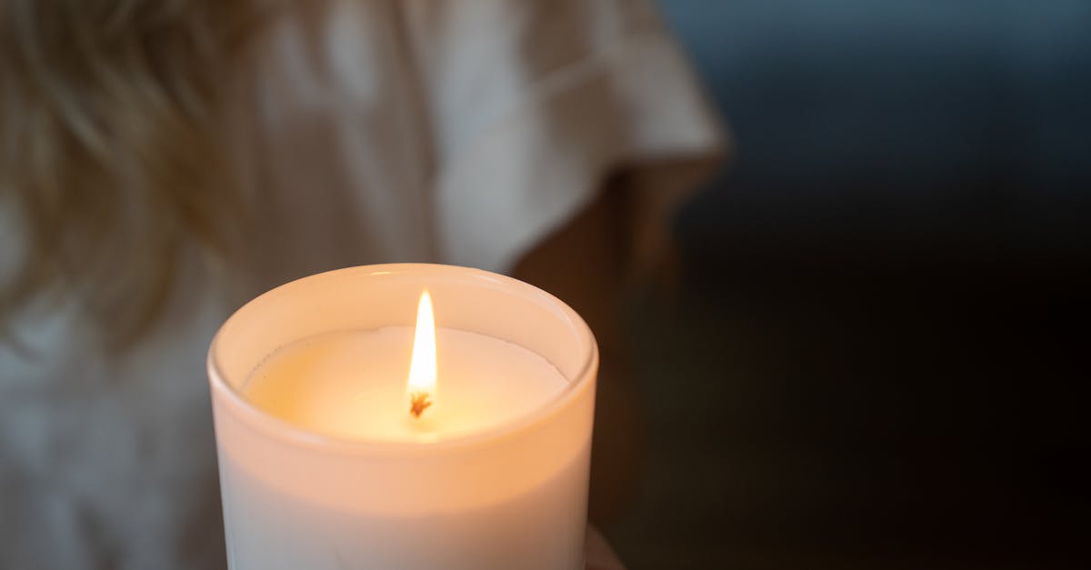 A serene close-up image of a lit candle creating a warm ambiance, ideal for relaxation themes.